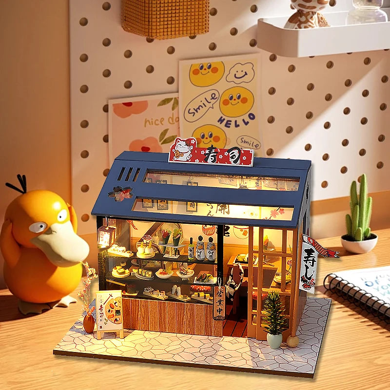 Maquette de restaurant japonais miniature éclairée posée sur un bureau en décoration
