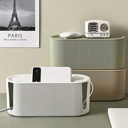 Boite de rangement multiprise verte avec smartphone et câbles branchés dans un intérieur épuré