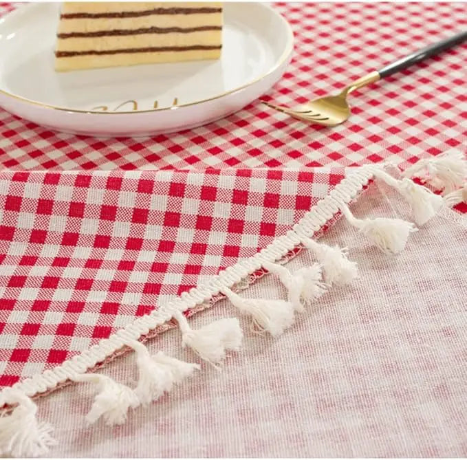 Détail des franges et du tissu d’une nappe vichy rouge en coton
